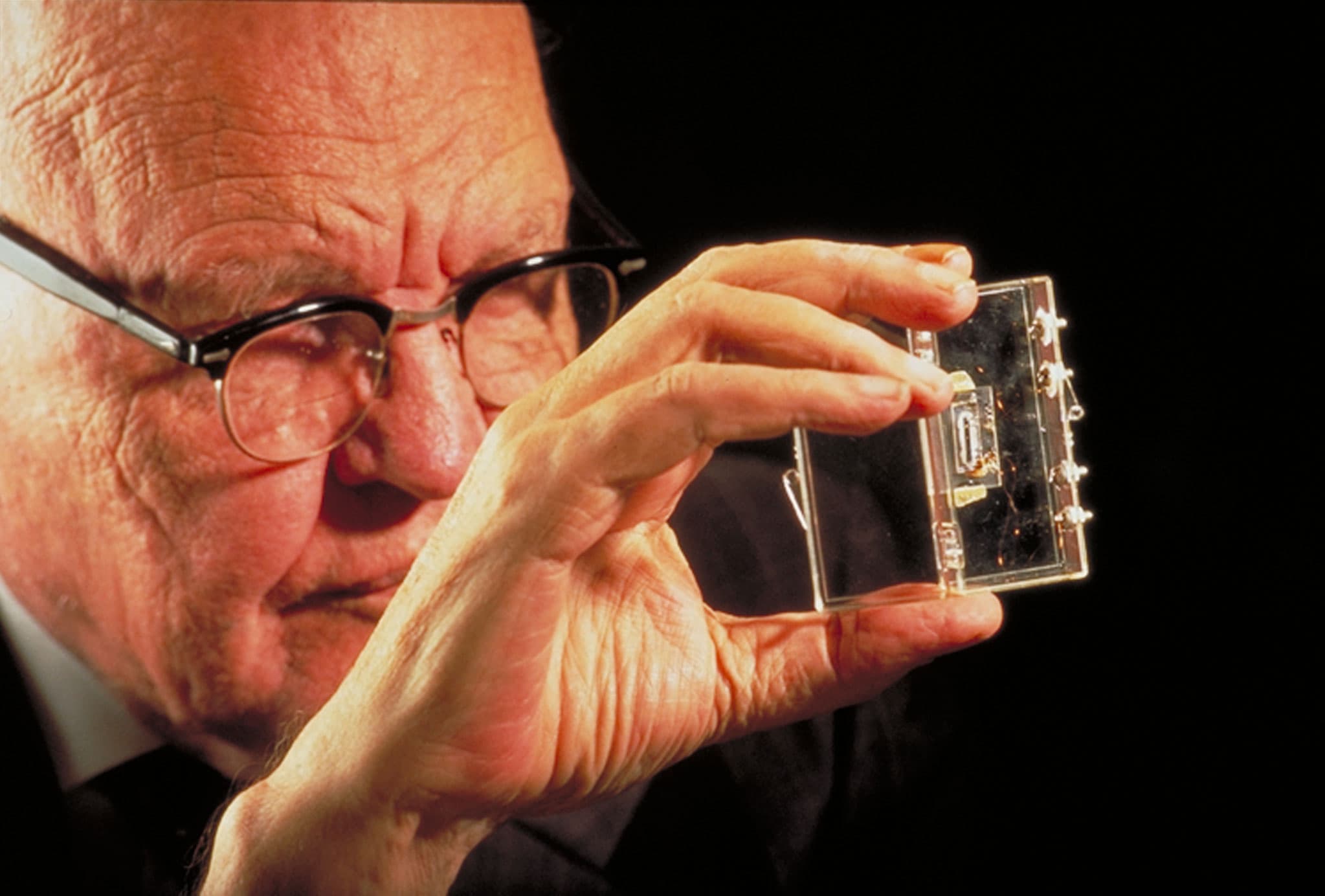 Jack Kilby holding the first integrated circuit